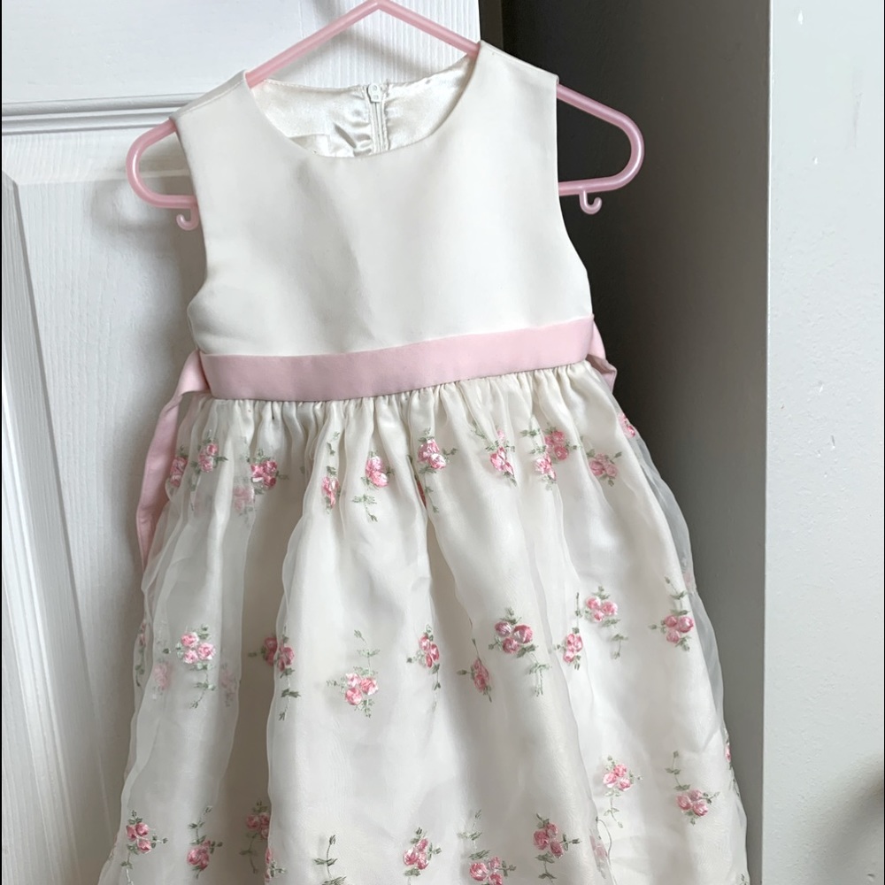 Toddler cream colored dress with pink embroidered flowers.